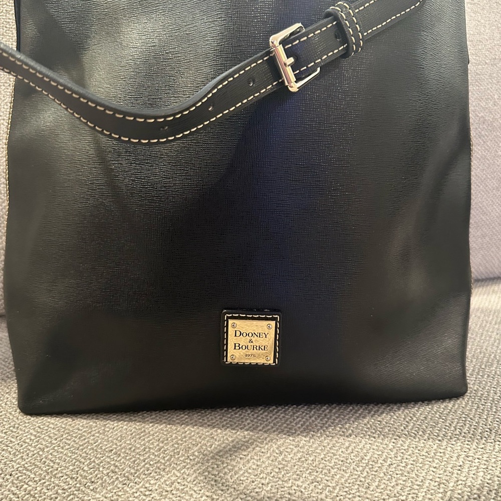 Dooney and Bourke. Great bag made of coated fabric.